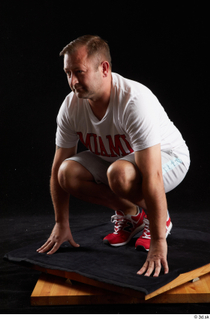  Louis  2 dressed grey shorts kneeling red sneakers sports white t shirt whole body 0002.jpg